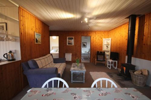 a living room with a couch and a table at Woodland Retreats in Fort William
