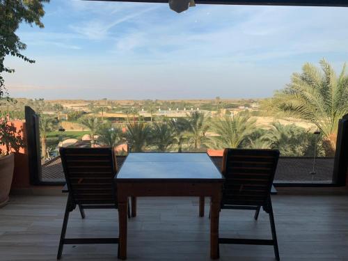 a table and two chairs on a patio with a view at Lazib Inn Resort & Spa in Tunis