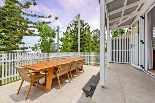 a wooden table and chairs on a patio at Hestia Villa - Luxury Retreat near CBD and Grammar in Toowoomba