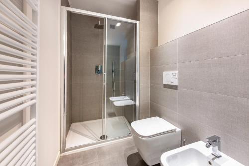 a bathroom with a shower and a toilet and a sink at Gemhouse Turchese garda lake in Gargnano