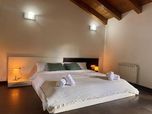 a bedroom with a large white bed with two pillows at Casacastillo28 in Peñarroya de Tastavins
