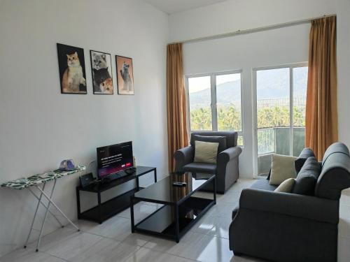 a living room with a couch and a chair at Langkawi Homestay Family Suite 3Bed Room in Kuah