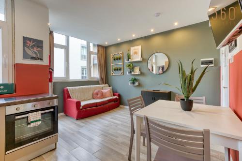 a living room with a table and a couch at Modern Paceville Suites with WIFI & AC by 360 Estates in Paceville