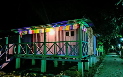 a colorful house with lights on it at night at Leo Jungle Retreat by StayApart , Jaldapara in Mādāri Hāt