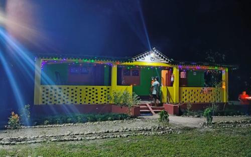 a person standing outside of a toy train at Leo Jungle Retreat by StayApart , Jaldapara in Mādāri Hāt