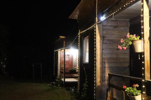 a house with lights on the side of it at night at Breathe Inn in Batumi