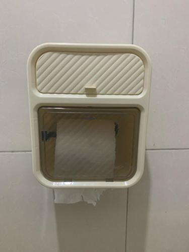 a window on the wall of a bathroom at Pakuwon ORCHARD Apartment by Dovey in Surabaya