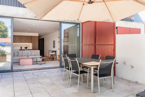 an open patio with a wooden table and chairs at VIVA Serralves Patio in Porto