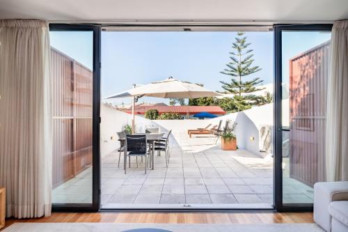 an open living room with a patio with a table and chairs at VIVA Serralves Patio in Porto