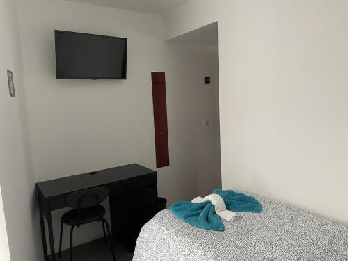 Ένα ή περισσότερα κρεβάτια σε δωμάτιο στο Hostal NANA B&B