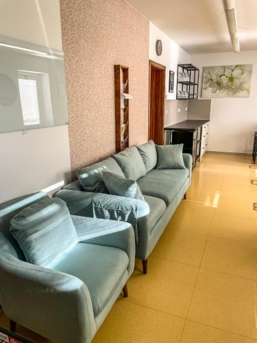 a living room with a couch and a fireplace at Slunečný Penzion in Tasovice