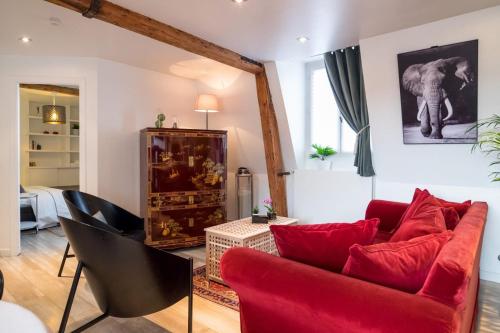 - un salon avec un canapé rouge et un éléphant dans l'établissement 2 bedroom apartment in the heart of the old town, à Lille
