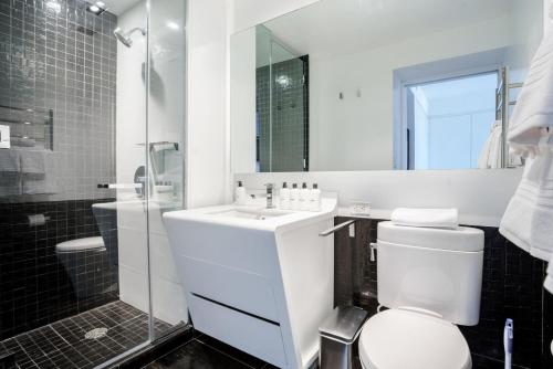 a bathroom with a toilet and a sink and a shower at Blueground Tribeca lounge nr WTC NYC-1375 in New York