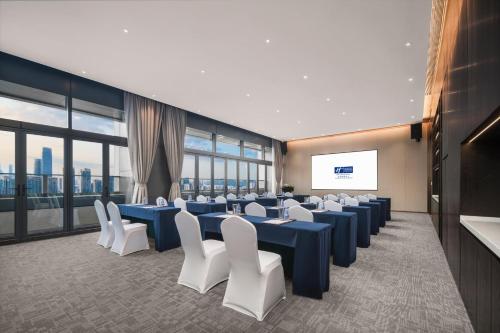 a conference room with blue tables and white chairs at Holiday Inn Express Shenzhen Futian Center by IHG in Shenzhen