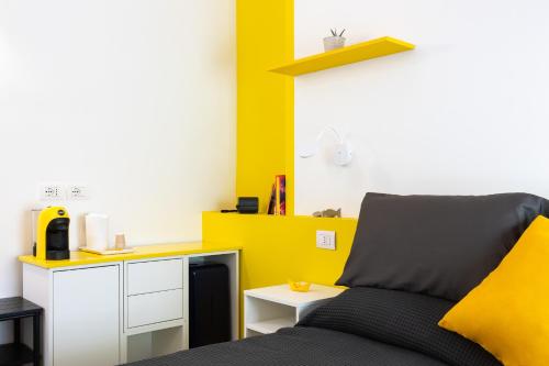 a bedroom with a bed and a yellow wall at Villa Bice in Bergeggi