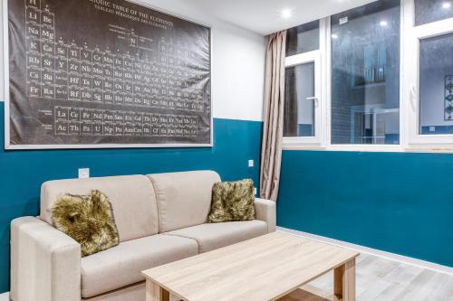 a living room with a couch and a table at Modern Paceville Suites with WIFI & AC by 360 Estates in Paceville