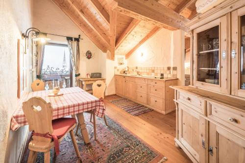 a kitchen with a table and chairs in a room at Haus Tirol in Molini di Tures