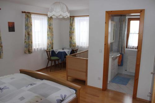 a bedroom with a bed and a bathroom with a sink at Ferienwohnung Löffelberger in Hallein