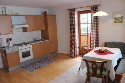 uma cozinha com uma mesa e uma cozinha com um fogão em Ferienwohnung Löffelberger em Hallein