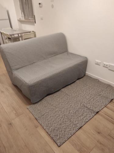 a bed sitting on the floor in a room with a rug at KAIROS RESIDENCE in Parma