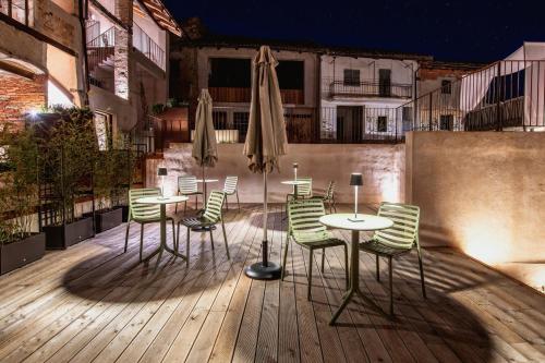 a patio with chairs and tables and umbrellas at Relais Chiarene in Novello