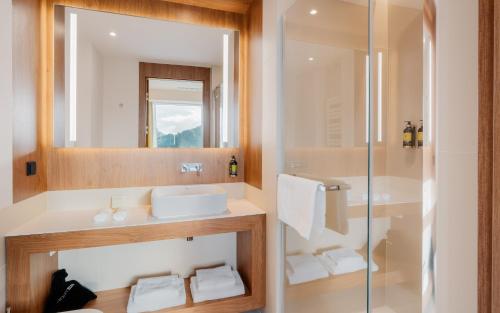a bathroom with a sink and a shower at Hotel Pieniny Grand Wellness & SPA - Destigo Hotels in Szczawnica