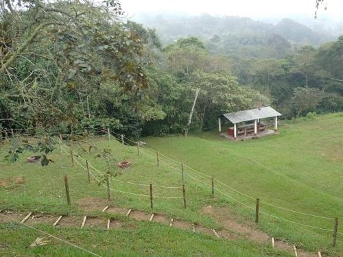 a pavilion in a field with a fence at Finca posada del camino real in Guaduas