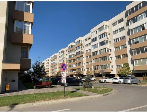 a parking lot in front of a large building at Luxury Apartament Bacovia in Bacău