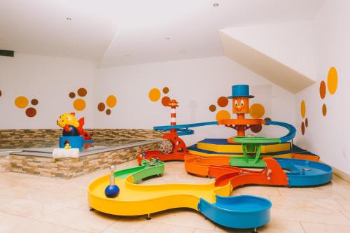 a childs play area with a play set in a room at Familienresort Buchau in Maurach