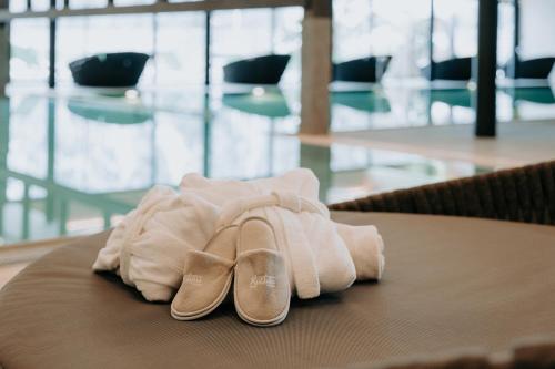 a pair of shoes and towels on a table at Familienresort Buchau in Maurach