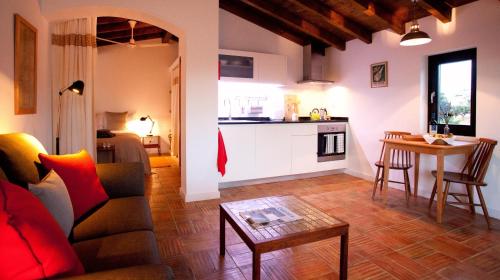 a living room with a couch and a table at Sernadinha in Aldeia do Cano
