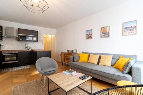 a living room with a couch and a table at Vieux Lille - center apartment! in Lille