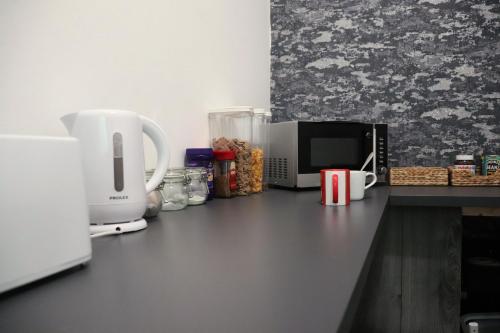 a kitchen counter with a microwave and a coffee maker at The Anfield View in Liverpool