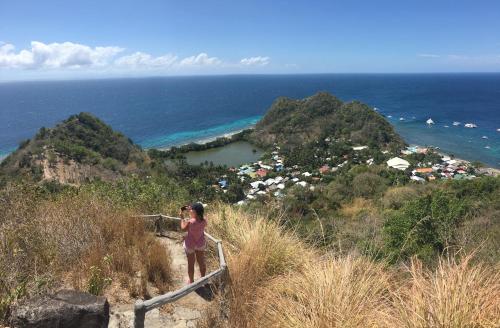 a woman taking a picture of the ocean at Liberty's Lodge and Diving - Apo Island in Dumaguete