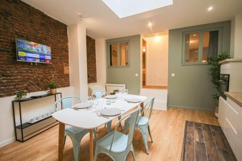 a dining room with a white table and chairs at Lille Grand Place - Apartment With 2 Bedrooms in Lille