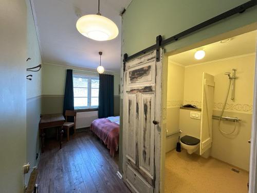 a bedroom with a bed and a door with a bathroom at Wilderness Center / Óbyggðasetur Íslands in Óbyggðasetur