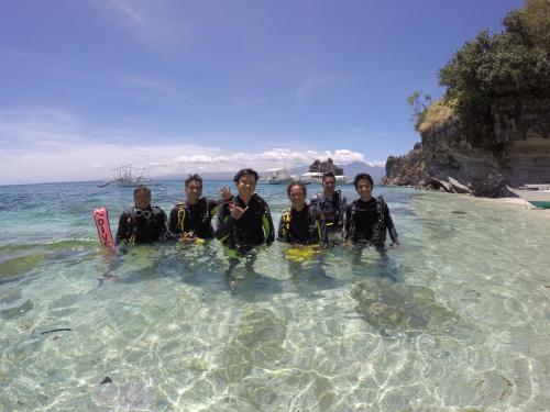 a group of people standing in the water at Liberty's Lodge and Diving - Apo Island in Dumaguete