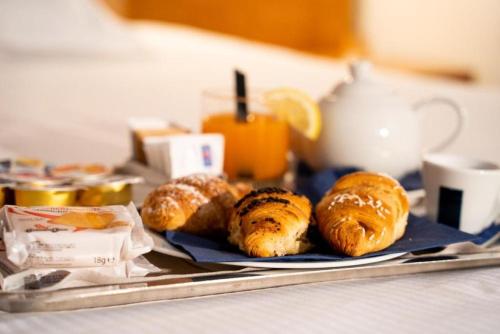a plate of croissants and pastries on a table at Best Western Hotel Fiera Verona in Verona