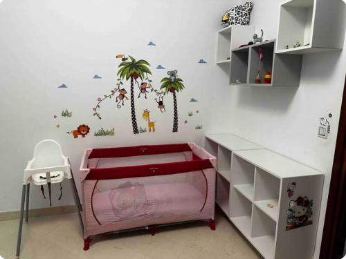 a childs room with a palm tree mural on the wall at Appartement à Bizerte in Bizerte