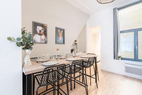 une salle à manger avec une longue table et des chaises dans l'établissement Lille centre - Nice flat with terrace!, à Lille