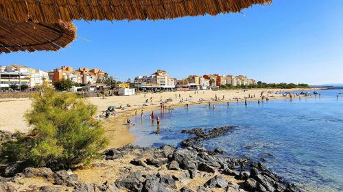 a beach with a bunch of people in the water at Studio Cap d'Agde in Cap d'Agde