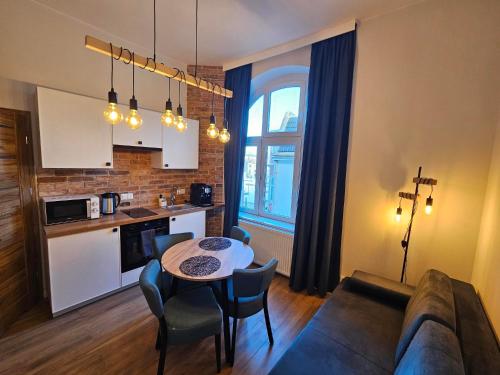 a living room with a couch and a table at Main Street Apartments in Sopot