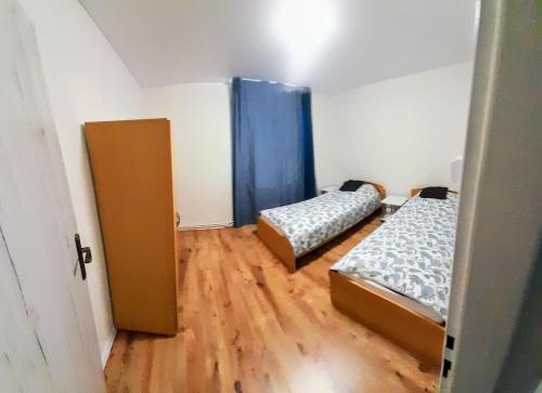a small room with two beds and a door at LEV I SOVA in Mělník