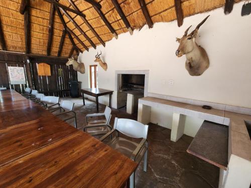 a dining room with a antelope head on the wall at Lama Lama Game Reserve in Mount Hope