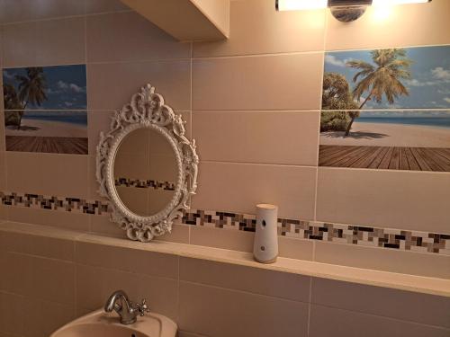 W łazience znajduje się lustro i umywalka. w obiekcie KANALU w mieście Bouillante