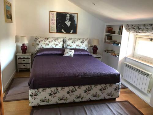 a bedroom with a bed and two tables and a window at Walking distance from Via Veneto in Rome