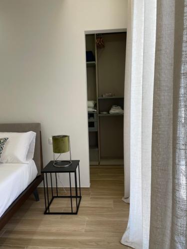 a bedroom with a bed and a table with a lamp at Casa Magrè in Agrigento