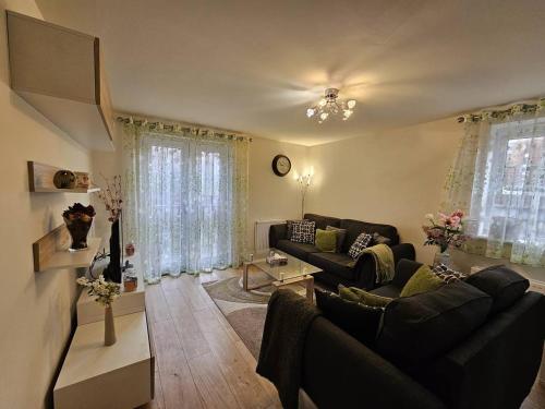 a living room with a couch and a table at Cosy & Stylish One-Bed Flat-close to Warwick Uni in Coventry