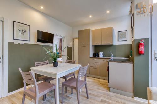 a kitchen and dining room with a table and chairs at Modern Paceville Suites with WIFI & AC by 360 Estates in Paceville
