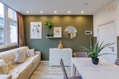 a living room with a couch and a table at Modern Paceville Suites with WIFI & AC by 360 Estates in Paceville